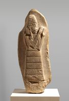 Stele with inscription showing the protectrice deity Lam(m)a, dedicated by king Nazi-Maruttash to goddess Ishtar, from Uruk (1307-1282 BC). Metropolitan Museum of Art.
