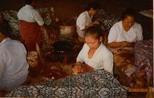 Batik craftswomen in Java handmarking resist on batik tulis cloth with canting