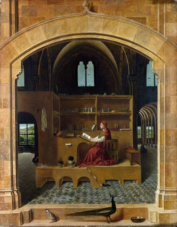 Oil on panel. The saint is a plump man in a red robe. His red cardinal's hat lies near him on a chair. There are many small details such as books and potplants. A peacock and partidge are walking near the arch that frames the scene.
