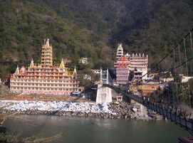 Rishikesh view and 13 stories Shiva temple across Lakshman Jhula bridge over the Ganges
