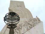 Monument to discoveries and a globe in front