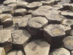 Naturally formed basalt columns from Giant's Causeway in Northern Ireland; large masses must cool slowly to form a polygonal fracture pattern