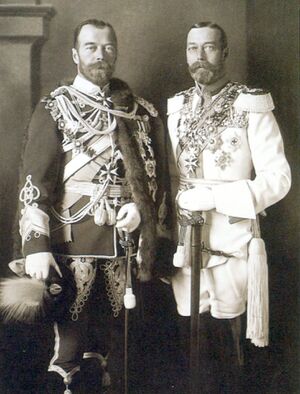 Two look-alike men. Both wear beards and are in full military regalia festooned with medals—one uniform dark, the other white.