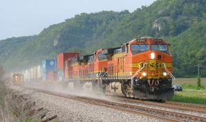 Orange locomotive hauling freight