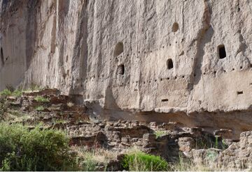 A Remains of multistory dwelling built into a volcanic tuff wall, Bandelier National Monument, New Mexico