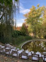 Art installation in the Dumbarton Oaks Garden showing school desks in front of the lake