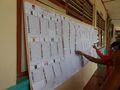 الناخبون يتفحصون قائمة المرشحون للانتخابات التشريعية.
