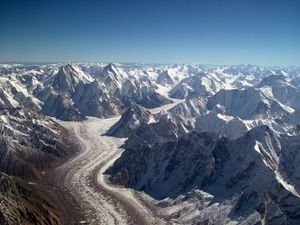 Glacier surrounded by mountains, seen from the air
