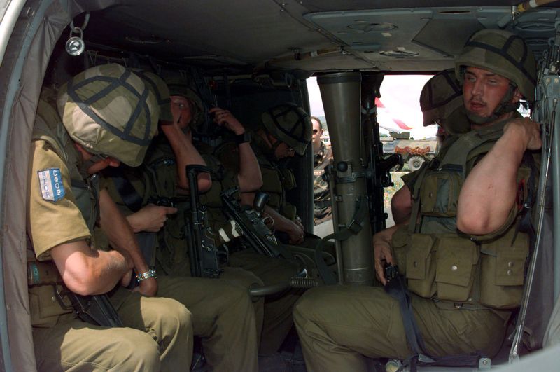 ملف:Norwegian mech battallion soldiers strapping into UH-60.jpg