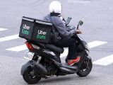 In the 2020s, multiple online food delivery services such as Uber Eats, Postmates, DoorDash and Grubhub became popular. Pictured above is an Uber Eats employee delivering a meal.