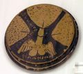 Attic red-figure lid. Three female organs and a winged phallus.