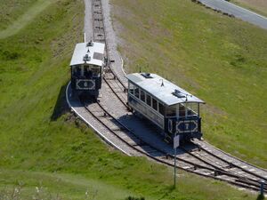 The two cars on the upper half of the Great Orme Tramway passing each other at a switch-controlled passing loop