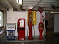 Display of various antique gas pumps at Deutsches Museum in Munich, Germany.