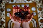 Her hands decorated with henna, an Afghan Muslim woman takes part in evening prayers during the Muslim holy month of Ramadan on August 13, 2010 in Kabul, Afghanistan. (Majid Saeedi/Getty Images)