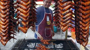 ماليزي يبيع أجنحة الدجاج المشوية في سوق بوسط مدينة كوالالمبور لإفطار رمضان.jpg