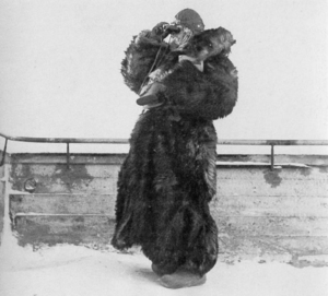 Two men with snowsuits aim a light machine gun at the front.