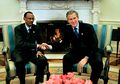 One of many hand-shake photos in front of the fireplace. The President sitting to the viewer's right, the guest to the left. One of the rare images where there is fire in the fireplace (March 2003, the guest is Paul Kagame.)