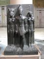 Menkaura flanked by the goddess Hathor (left) and a nome goddess (right). Basalt statue in Cairo Museum.