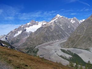 a glacier covered with rocky debris flowing down the Italian side of Mont Blanc