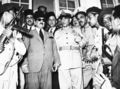 General Mohamed Neguib Bey, centre in uniform, who engineered the recent coup d'etat in Egypt, with newly appointed Premier Aly Maher, in sunglasses, at Maher's office in Alexandria, July 26, 1952. Maher has just delivered an abdication ultimatum to King Farouk. The king abdicated in favour of his seven-month-old son, Prince Ahmed Fuad, and left the country for Italy on his royal yacht. (AP Photo)
