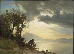Painting with a view from the shore of Lake Tahoe. A boulder is perched on rocks on the shore, trees to the left, a bird is flying close to the water and a mountain is in the distance.