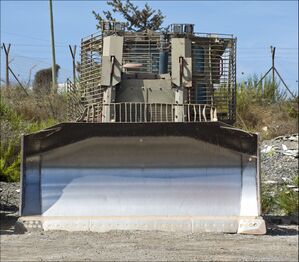 IDF D9R/T (4th generation armor) parking near a military outpost (front view)