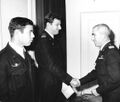 Navy Commander General Avraham Butzer congratulates Capt. Dov Bar and Sgt. Zalman Roth who won the exemplary decoration for their activities in the raid on Green Island.