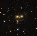 "Smiley" image - galaxy cluster (SDSS J1038+4849) & gravitational lensing (an Einstein ring) (HST).[7]
