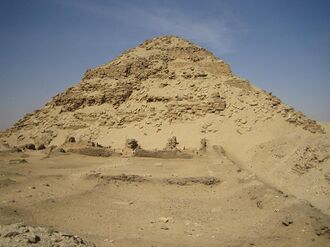 Great but ruined pyramid made of bricks and stones in the desert.