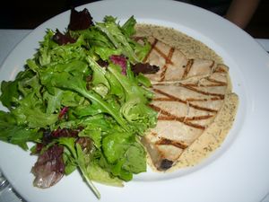 Photo of plate containing grilled tuna and leafy vegetables