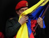 Enezuelan President Hugo Chavez kisses a Venezuelan national flag july 2011.jpg