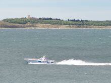 Small police boat on large body of water