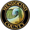 The county's official seal, in chief two redwood trees and the numbers '1850', a breaking wave on the Pacific Ocean and a vineyard set in relief, bordered by a dark brown circle with the words 'Mendocino County' appearing within the border in gold block letters