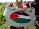 Palestinian child holds a sign on Land Day.jpg