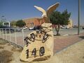 A sculpture of 140 Squadron "Golden Eagle" near a parking area at Nevatim