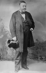 Grant is standing in a civilian dress suit holding a top hat after the Civil War.