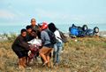 People carry a victim in Palu on September 29.jpg