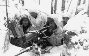 A group of soldiers with snowsuits aims a heavy machine gun.