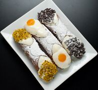 Cannoli with pistachio dust, candied and chocolate drops