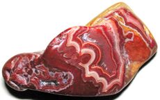 A group of tumble polished agates showing banding in red, orange and white with crystal interiors.