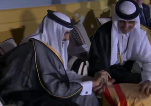 تميم بن حمد أمير قطر، يهدي والدهه حمد بن خليفة قميصاً رياضياً مطابقاً للذي كان يرتديه حمد في شبابه. ضمن حتفالية افتتاح كأس العالم 2022 (20 نوفمبر 2022)
