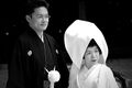Japanese bride and groom, wearing white and black kimonos respectively.