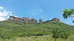 Rock formations on the top of a hill, lush green vegetation