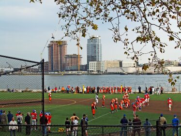 The East River passes children playing football in East River Park (2008)