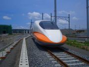 An orange and white high speed train
