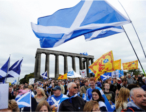 اسكتلنديون مؤيدون لانفصال اسكتلندا عن المملكة المتحدة يلوحون بالعلم الاسكتلندي قبل التوجه استفتاء الاستقلال، 2014.