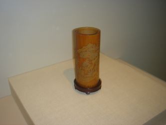 A bamboo brush holder or holder of poems on scrolls, created by Zhang Xihuang in the 17th century, late Ming or early Qing Dynasty. In fanciful Chinese calligraphy in Zhang's style, the poem Returning to My Farm in the Field by the 4th century poet Tao Yuanming is incised on this cylindrical bamboo holder.
