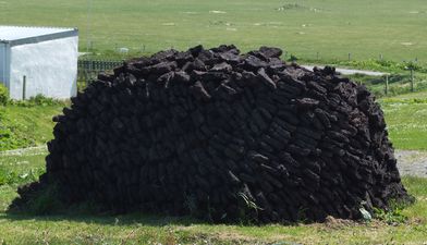 A stack of peat cut from the earth in the Outer Hebrides, Scotland. Peat is partially decayed vegetative matter.