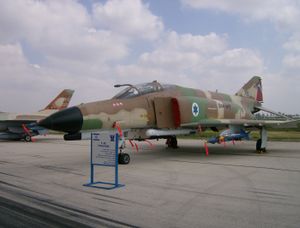 An aircraft with earth colored camouflage and Israel's roundel (blue Star of David on a white background).