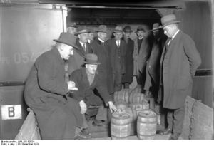 men standing around looking at barrels